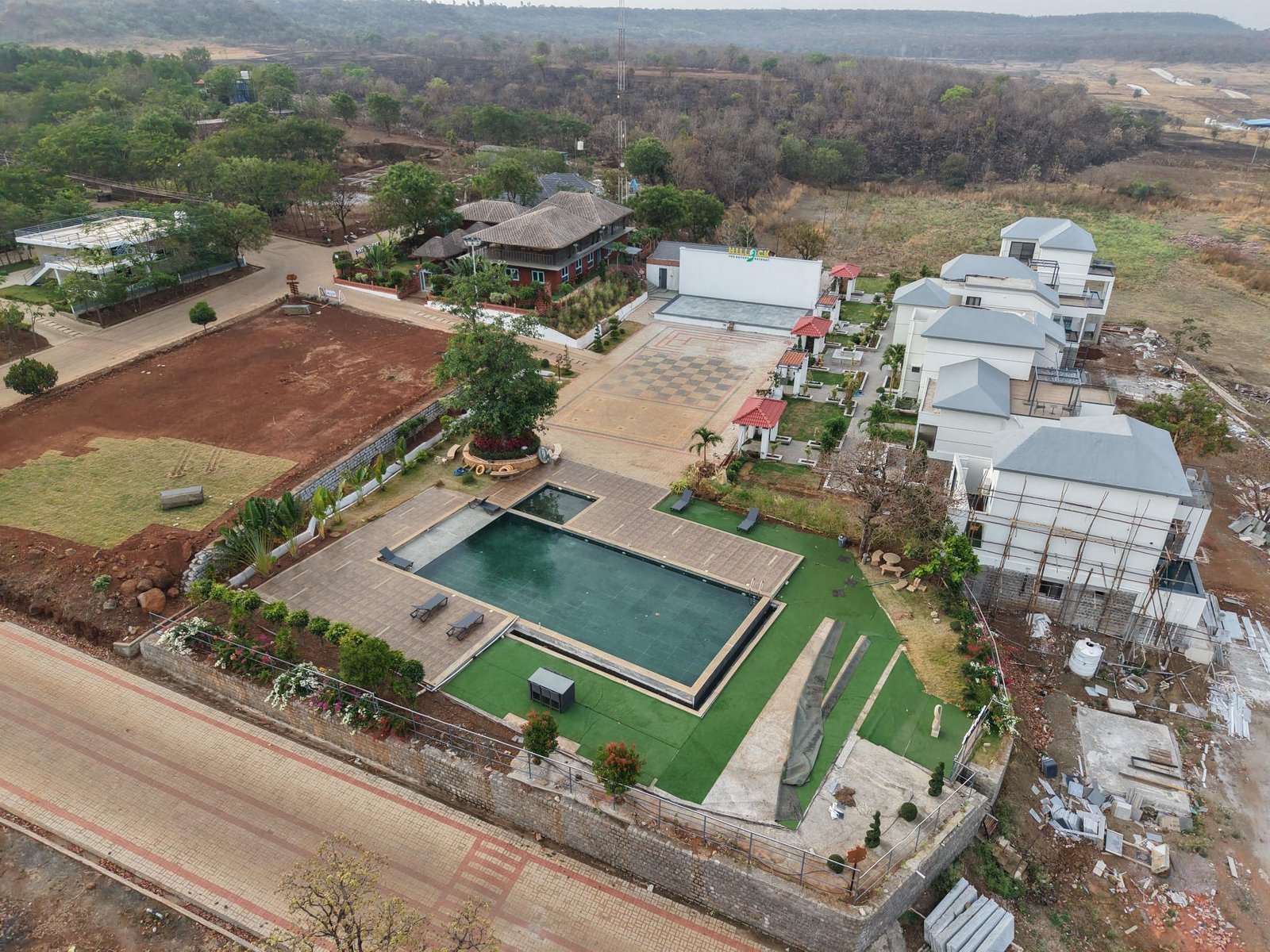 Aerial view of Hillock Resorts with pool and cottages